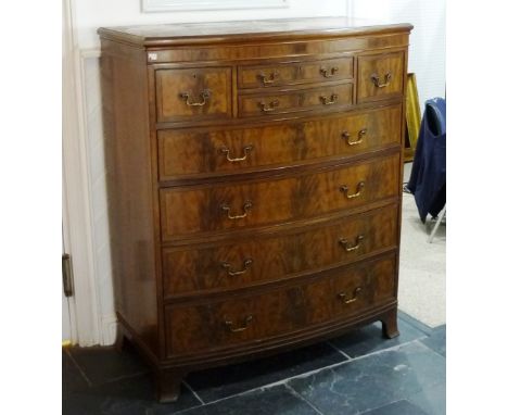 A Heals of Tottenham Court Road mahogany bow-front Chest of Drawers, bearing plaque to top right hand drawer, the shaped rect