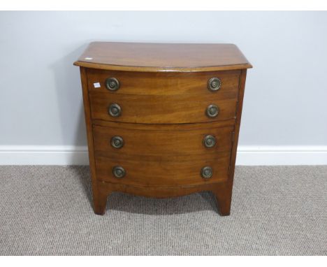 A Victorian mahogany bow-front Commode, in the form of a chest of four drawers, with two cupboard doors on bracket feet, 25½i