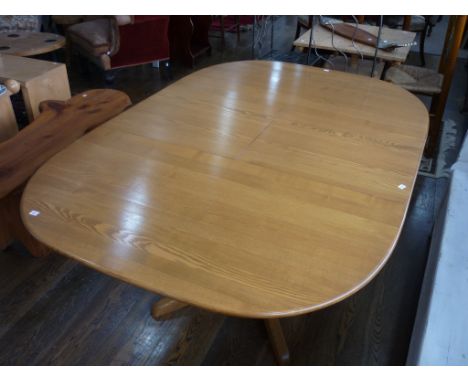 An Ercol light elm extending Dining Table, 66in (169cm) long when extended, 43in (110cm) wide, with two original ercol sticke