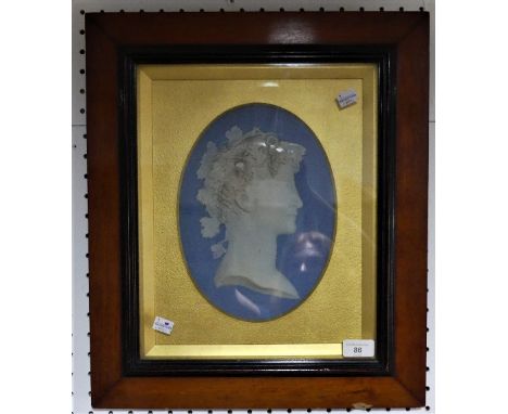 A Wedgwood Jasperware portrait Plaque,&nbsp;in blue ground, Bacchanal, in ovular mount, framed and glazed, with a cut verso t