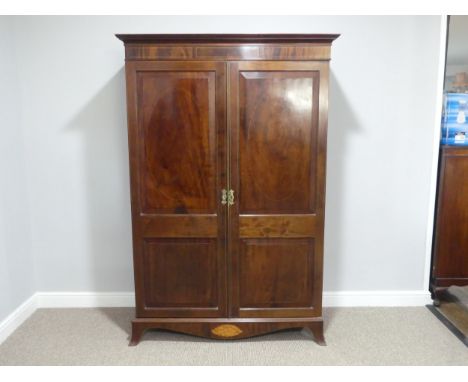 An Edwardian mahogany Wardrobe, with panelled doors, boxwood stringing and shell inlay, on bracket feet, 48in (122cm) wide x 