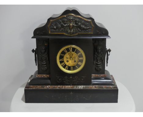 A large Victorian black slate Mantel Clock, with classical styling, with key, 19in (48.5cm) wide, 18½in (45.5cm) high. 