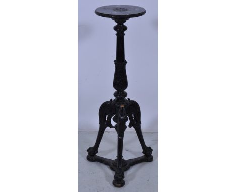 Ebonised torchere, circular top, leaf capped column on tripod legs with carved knees, ball and claw feet, height 104cm.