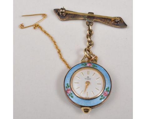 Bucherer yellow metal and enamel pendant watch, on a bow shape brooch, marked 925.