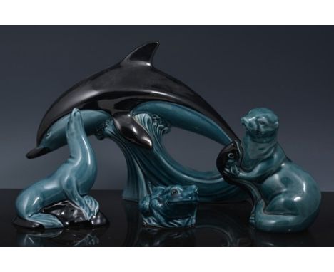 Three Poole pottery models of leaping dolphins, 18cm and smaller and other items of Poole pottery (10).