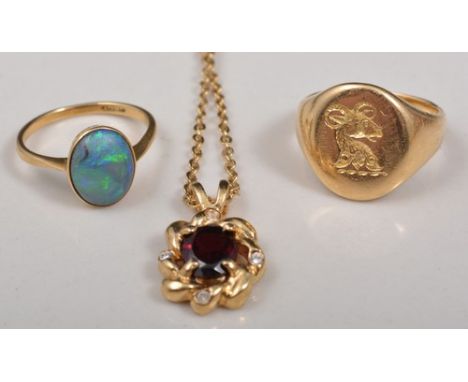 Hallmarked gold signet ring, marks rubbed, 15ct gold opal set ring and a garnet pendant on a trace link chain.