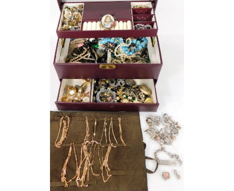 A purple leather jewellery box and contents, to include gold plated necklaces, silver charm bracelet, portrait brooches, gold