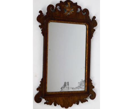 A 19thC mahogany fret mirror, in carved scroll case, centred by a gilded ho ho bird with a carved gilt wood carving to the su