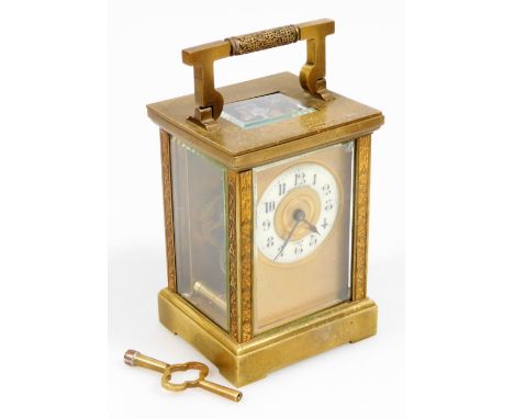 An early 20thC brass carriage clock, with swing handle, five part glass case on bracket feet, with back plate, 4cm Dia Arabic