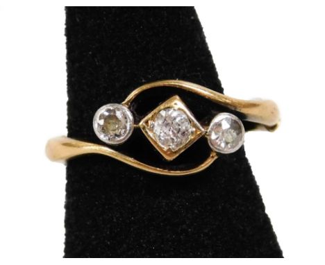 An Art Deco 18ct gold diamond ring, with central round brilliant cut stone in square border, with two round brilliant cut sto