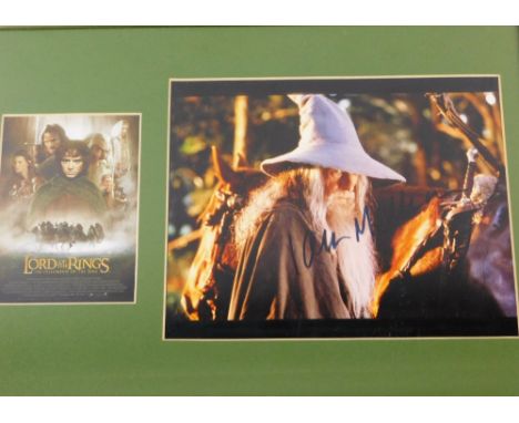 A Lord Of The Rings framed postcard and photographic print, signed Ian McKellen, glazed and framed, 31cm x 43cm.