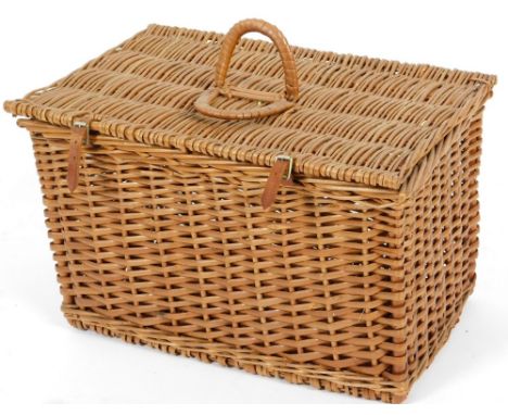 A 20thC wicker picnic hamper, with C shape handle and leather straps, 55cm W.