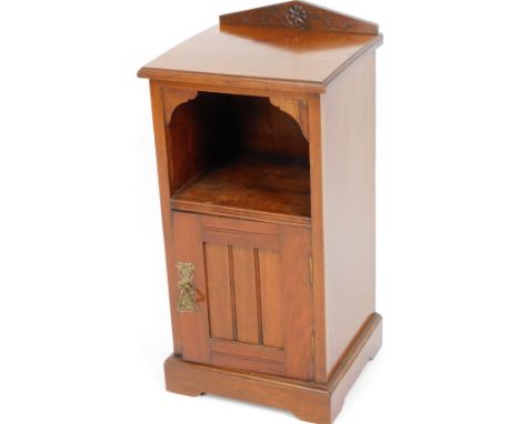 An Edwardian walnut pot cupboard, the angular pediment centred by a floral patera above an open shelf and cupboard, 25cm H, 3