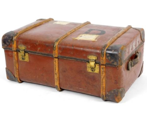 An early 20thC Orint brown leather steamer trunk, with part wooden banding studded spandrels with side carrying handles and a