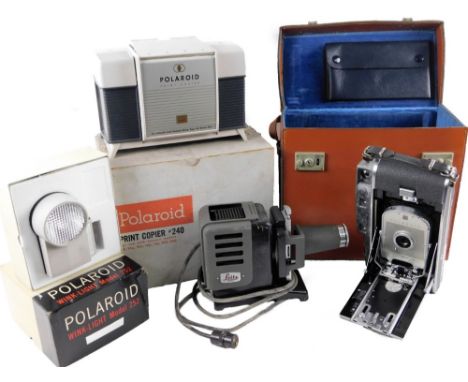Various optical equipment, etc, comprising, a Leitz Prado 150 slide projector, 16cm H, (boxed, with accessories), a Polaroid 