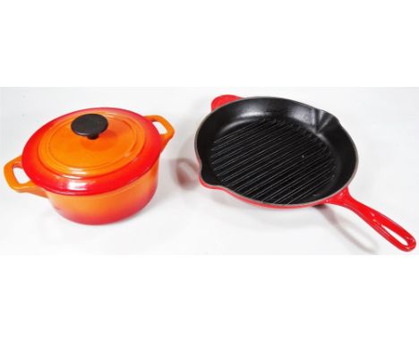A Le Creuset griddle pan, and a similar lidded casserole dish, in orange. (2)