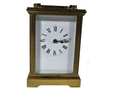 A 20thC brass carriage clock, with swing handle and rectangular case, on bracket feet, in a five part glass case, with a Roma