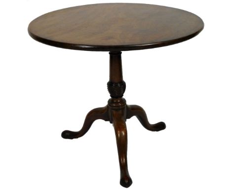 A George III mahogany tripod table, with one piece circular top, raised on a gun barrel support, terminating in cabriole legs