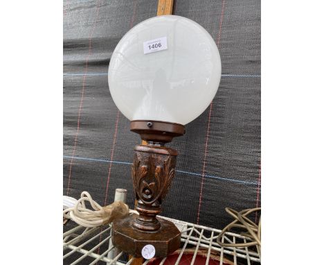 AN OAK CARVED TABLE LAMP WITH OPAQUE GLASS SHADE 