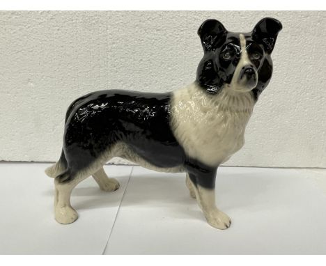 A LARGE CERAMIC FIGURE OF A BLACK AND WHITE COLLIE DOG 