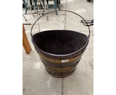 A VINTAGE WOODEN AND BRASS BANDED BUCKET 