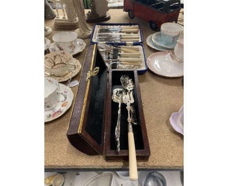 A BOXED VINTAGE FISH KNIFE AND FORK SET PLUS A BOX CONTAINING A SERVING SET 