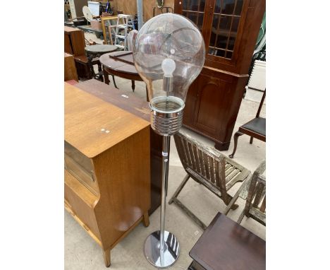 A CHROME STANDARD LAMP IN THE FORM OF A LARGE LIGHT BULB 