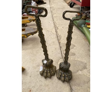 A PAIR OF VINTAGE BRASS COATED LION PAW DOOR STOPS 