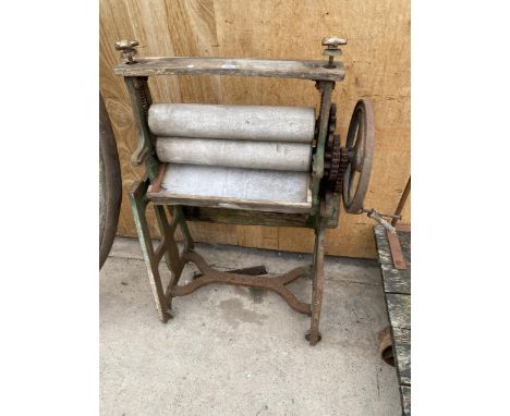 A VINTAGE CAST IRON AND WOODEN MANGLE BEARING THE NAME 'BRADFORD &amp; CO MANCHESTER AND LONDON' 