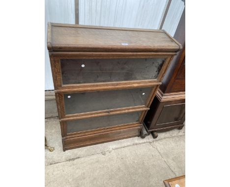 A GLOBE WERNICKE BOOKCASE WITH THREE GLAZED UP AND OVER DOORS 