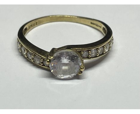 A 9 CARAT GOLD RING WITH A CENTRE CUBIC ZIRCONIA AND TEN ON THE SHOUDLERS SIZE N/O 