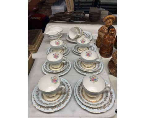 A GLADSTONE CHINA TEASET IN PALE BLUE WITH FLORAL AND GILT DECORATION TO INCLUDE CAKE PLATE, CREAM JUG, SUGAR BOWL, CUPS, SAU