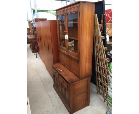 AN ERCOL COCKTAIL LOUNGE UNIT WITH TWO DOOR GLAZED UPPER PORTION, 38.5" WIDE 