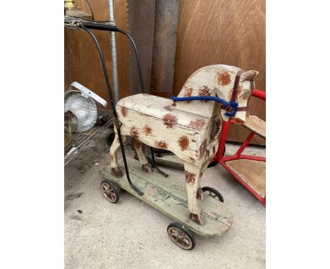 A VINTAGE CHILDRENS PUSH ALONG HORSE 