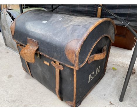 A VINTAGE LEATHER COVERED DOMED TOPPED TRAVEL TRUNK 