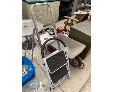 A METAL WHEEL BARROW, A SMALL TWO STEP LADDER AND A THREE RUNG ALUMINIUM STEP LADDER 