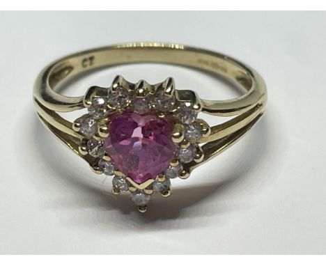 A 9 CARAT GOLD RING WITH A HEART SHAPED PINK STONE SURROUNDED BY CUBIC ZIRCONIAS SIZE I/J 