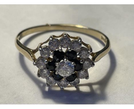 A 9 CARAT GOLD RING WITH SAPPHIRES AND CUBIC ZIRCONIAS IN A FLOWER DESIGN SIZE T/U 