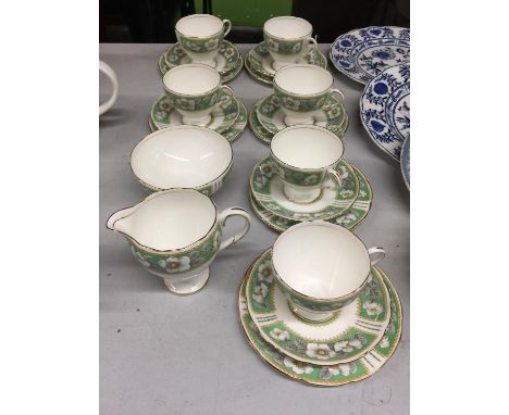 A CHINA TEASET IN A GREEN AND WHITE FLORAL PATTERN TO INCLUDE CUPS, SAUCERS, SIDE PLATES, CREAM JUG AND SUGAR BOWL 