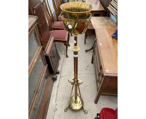 AN ADJUSTABLE BRASS OIL LAMP STANDARD WITH BRASS PLANT STAND, ON CLAW FEET