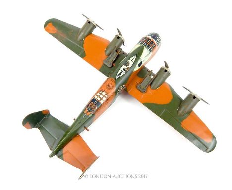 An American Marx tinplate model B52, friction clockwork plane with spark firing guns; 34cm long. 
