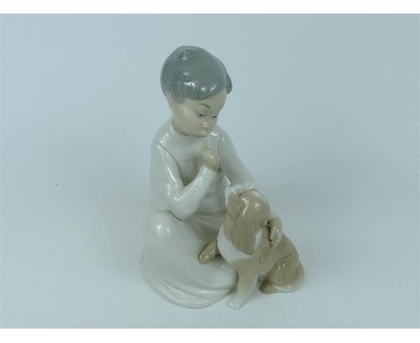 A Lladro porcelain figurine of a boy with a puppy; 19.5cm high.