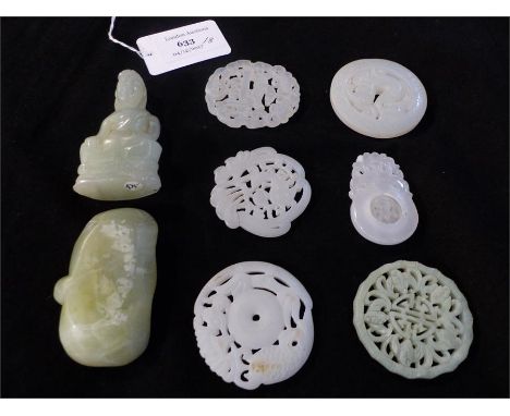 A collection of eight Chinese carved jade items, including pendants.and a Buddha figure.