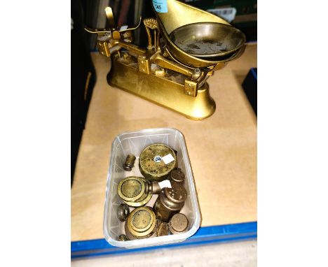 A set of brass and cast metal kitchen scales and a selection of weights 