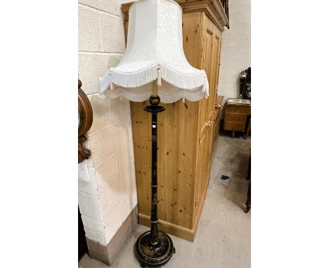 An early 20th century standard lamp, black lacquered with cream shade 