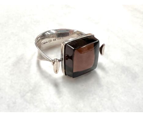 Georg Jensen:  a tapering silver bangle, designed by Vivianna Torun Bülow-Hübe, the top set large square smoky quartz, 3.5cmM