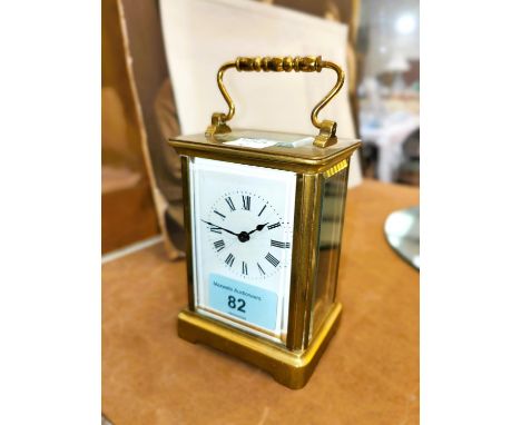 A 19th century French carriage clock with white dial and timepiece movement 