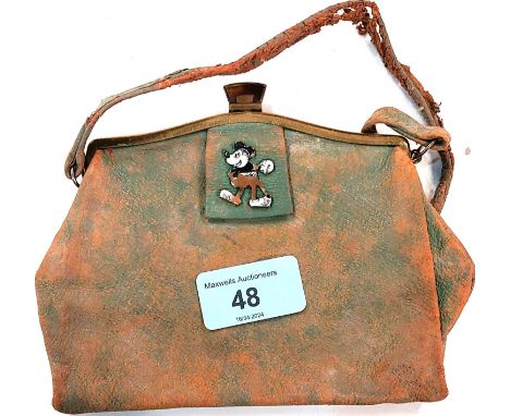 A 1930's unusual leather purse set with an enamel depicting an early Mickey Mouse (enamel a.f., handle worn) 