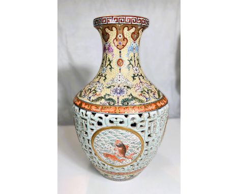 A large and impressive Chinese vase with pale blue reticulated body with decorated inner body, panels of polychrome carp and 