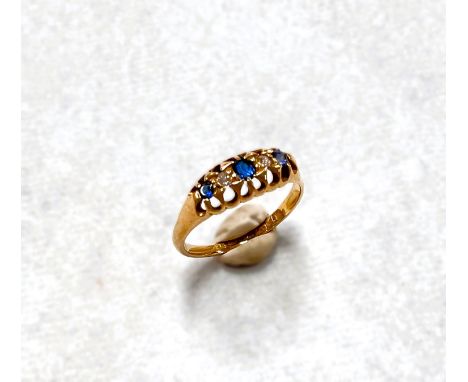 An 18 carat hallmarked gold ring with 3 sapphires and 2 diamonds alternately in raised claw setting, size Q/R, 3.1gm 